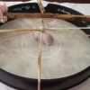A drum with some sticks around it