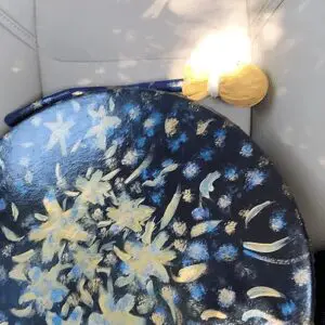 A blue and yellow plate with flowers on it