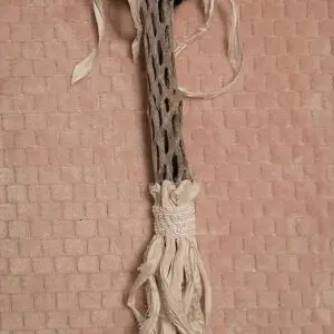A close up of a woven object on the wall