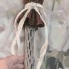 A person holding onto a white ribbon
