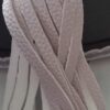 A close up of the white leather on a pair of shoes