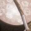 A wooden stick with white roses on it.