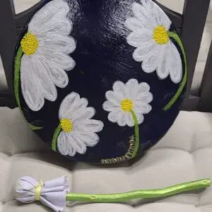 A black bag with white daisies on it