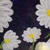 A close up of some white flowers on a black background