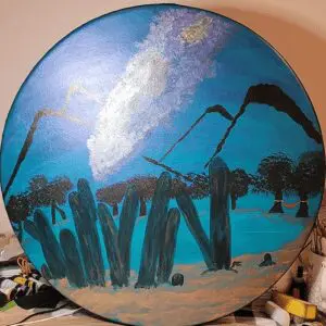 A painting of trees and rocks on top of a table.