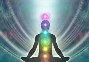 A person sitting in the lotus position with seven chakras on their shoulders.