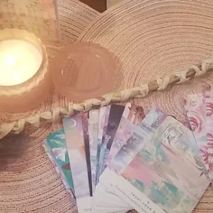 A candle and some cards on the table