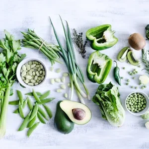 A table topped with lots of green vegetables.