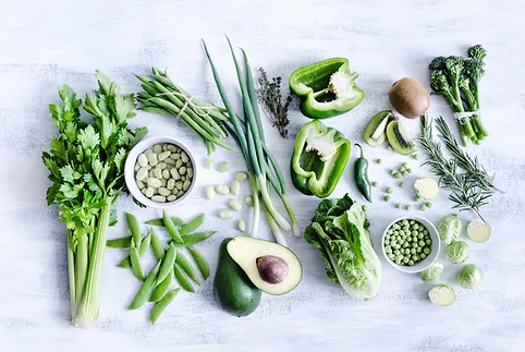 A table topped with lots of green vegetables.